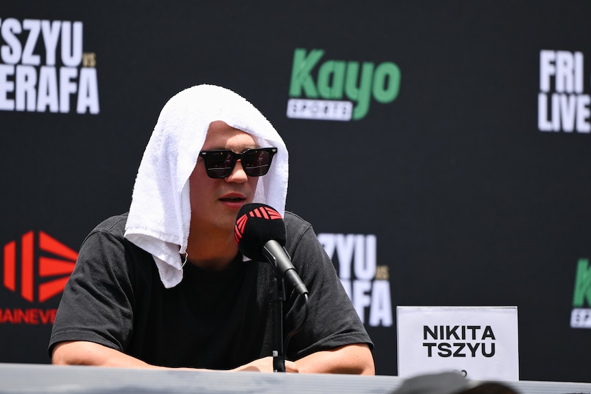 Nikita Tszyu sits with a towel on his head.