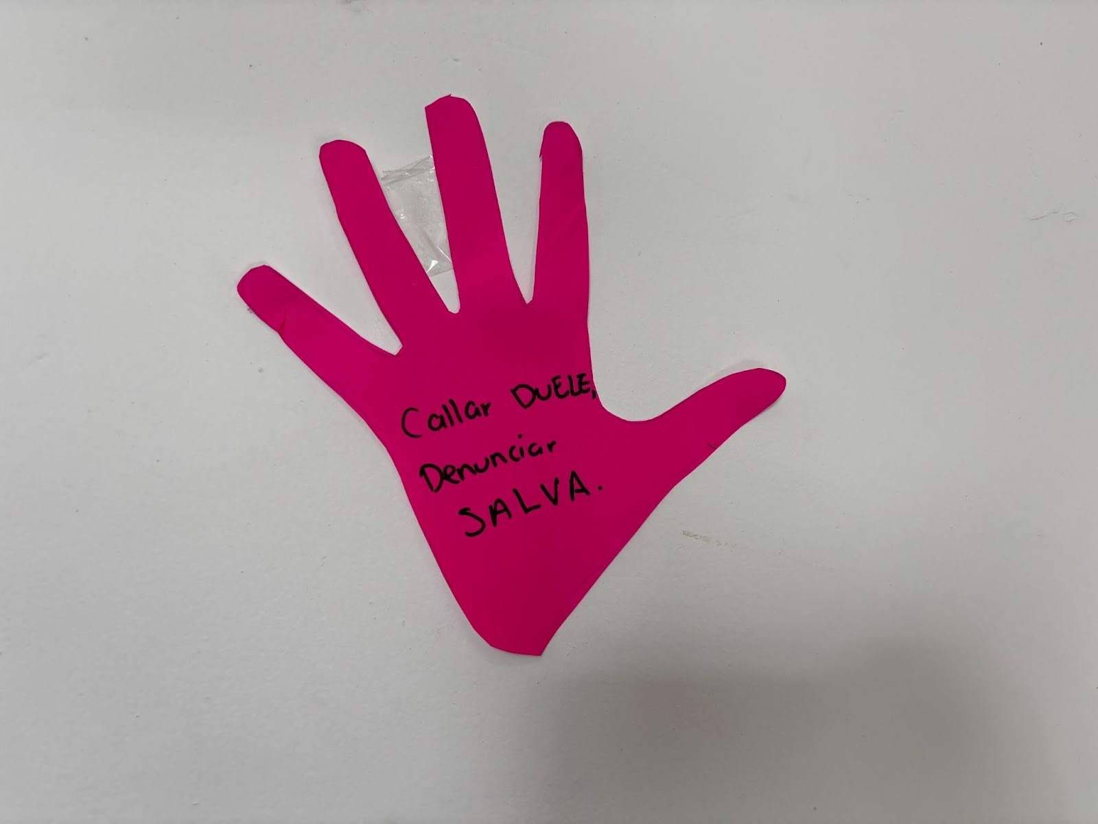A cutout of a hand that says “Silence hurts, reporting saves lives”, on the wall in the Popayán City Hall, Cauca