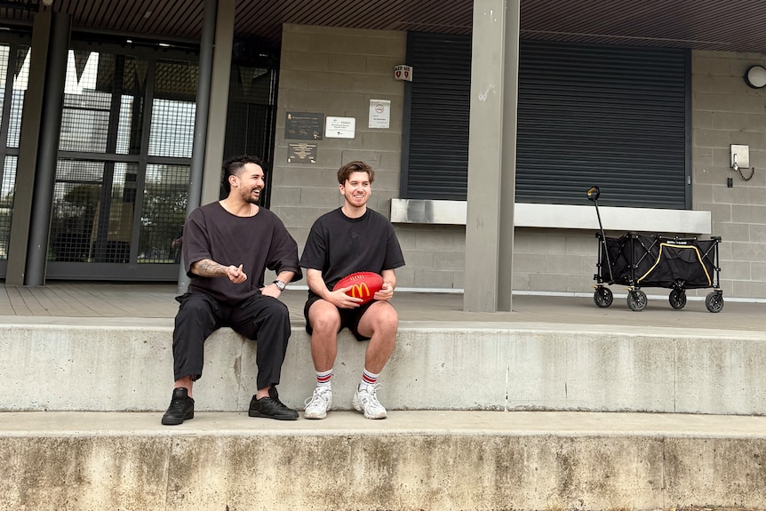 Two frineds at a footy ground