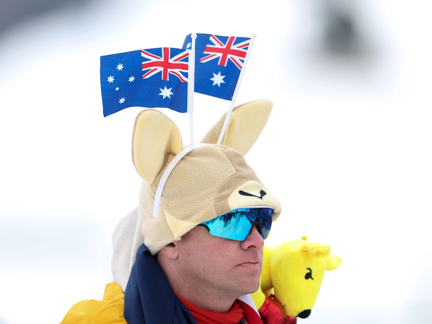A fan at the Winter Olympics wears a hat with kangaroo ears and two Australian flags