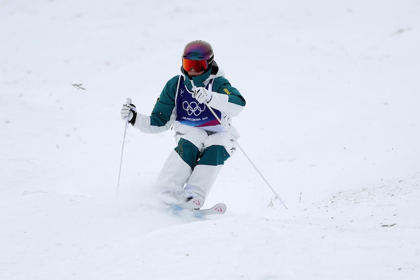 Australian Jakara Anthony shifts direction with her knees as she descends a moguls run at the Winter Olympics.