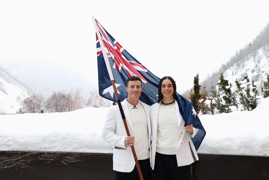 Matt Graham and Jakara Anthony with a flag