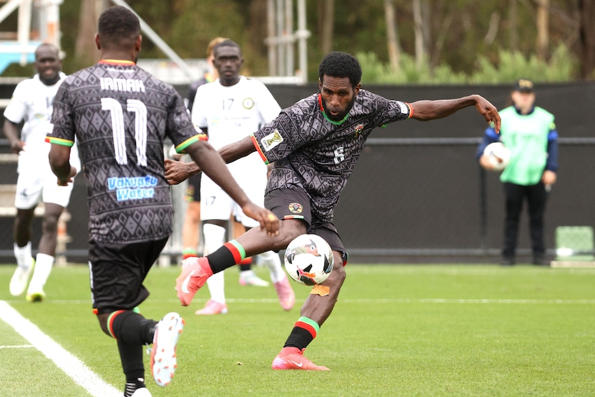 A Vanuatu footballer takes a shot on goal.