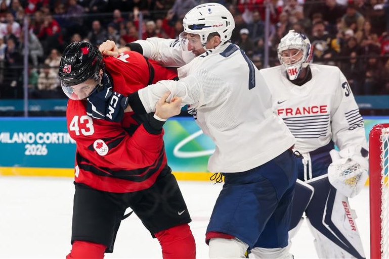 Peirre Crinon punches Tom Wilson during an Olympice ice hockey game.