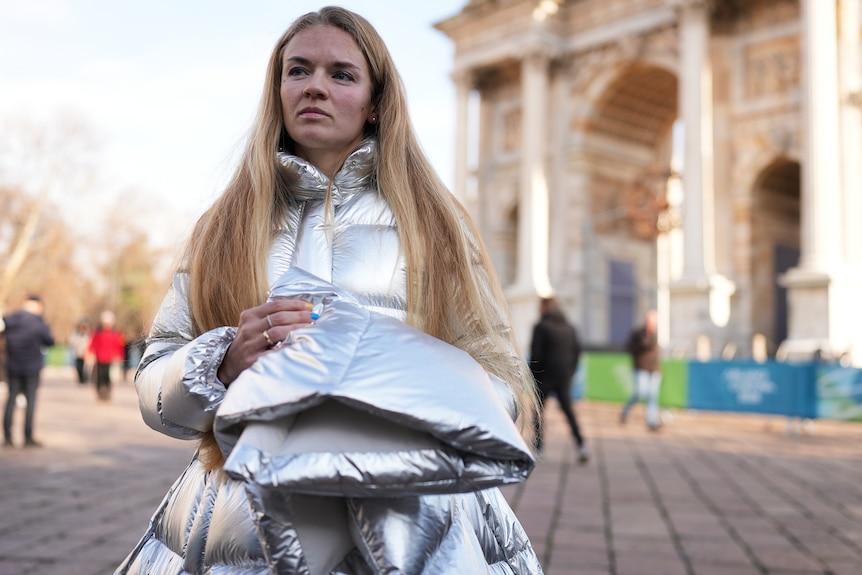 Anastasia Kucherova stands near the Arco della Pace during the 2026 Winter Olympics.