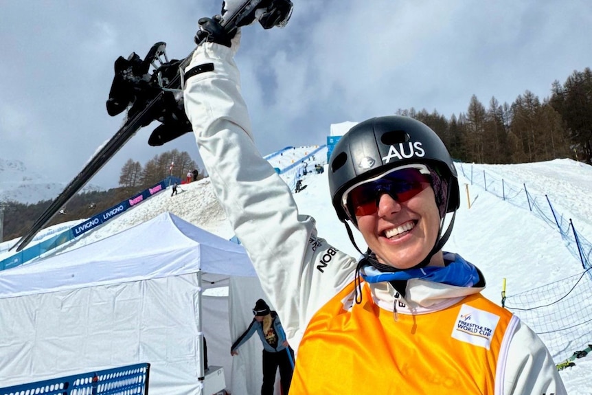Laura Peel celebrates by holding up her skis