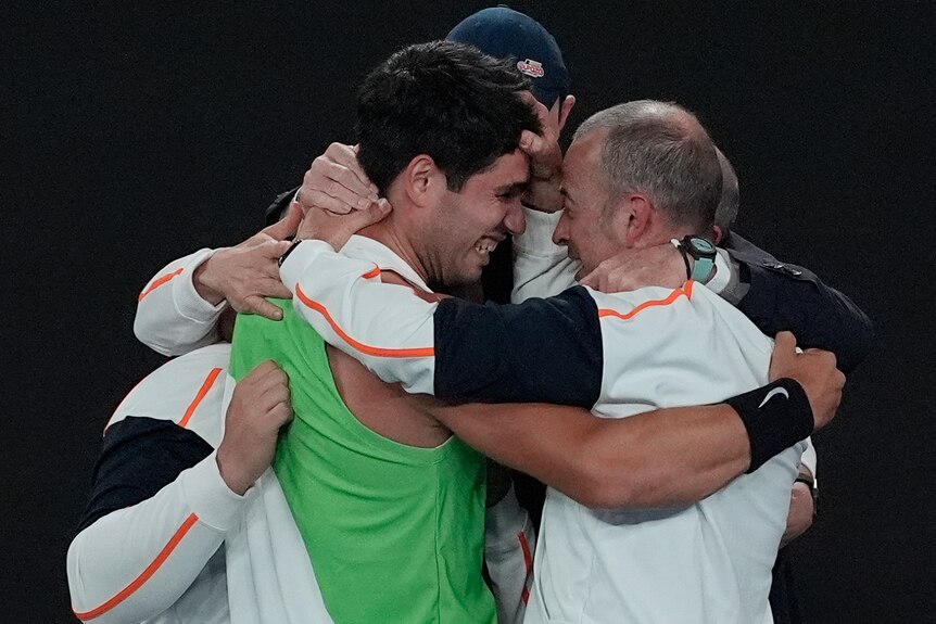 Carlos Alcaraz embraces his support team after winning 2025 Australian Open.
