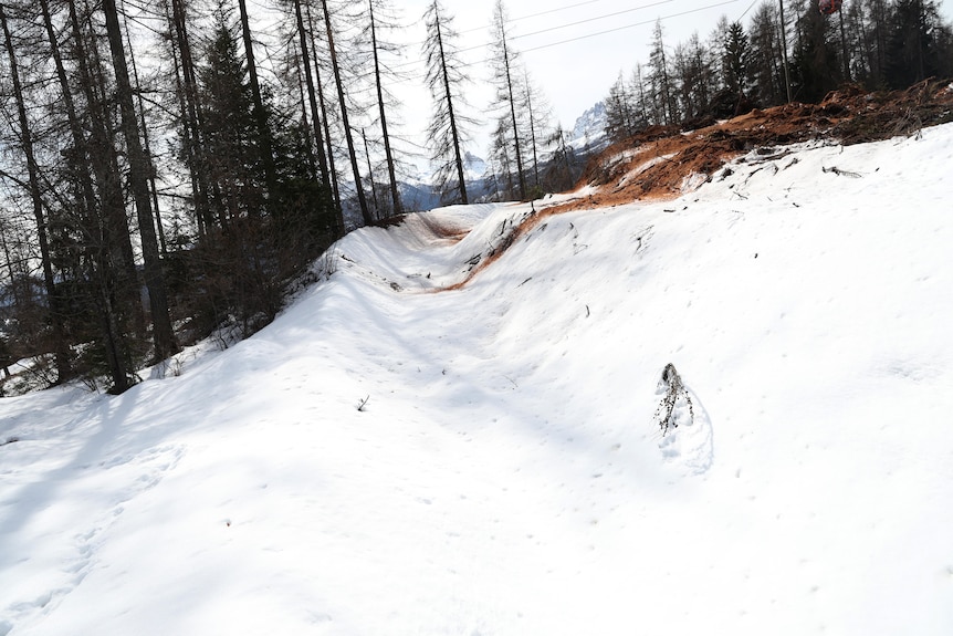 An abandoned bobsled track in the forest.