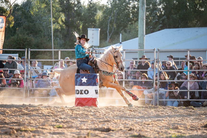 A woman barrel racing