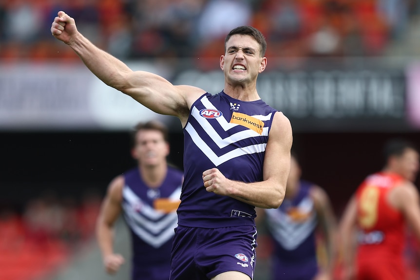 Patrick Voss raises his right arm in celebration