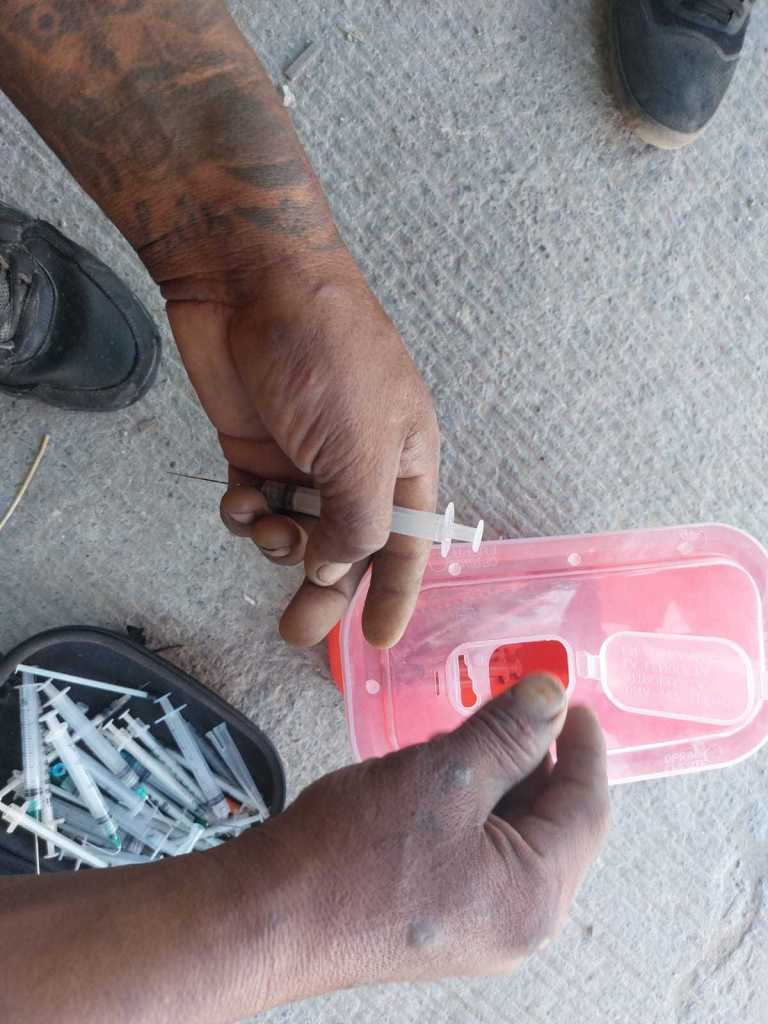 A heroin user exchanges used syringes for sterilized ones in Ciudad Juarez Mexico