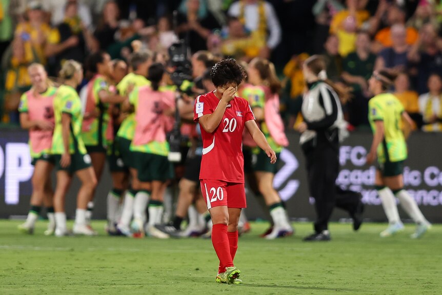 A North Korean women's footballer has hand on her head disappointed