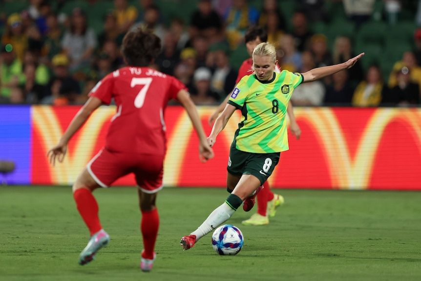 Matildas player Kaitlyn Torpey prepares to kick the ball during a game