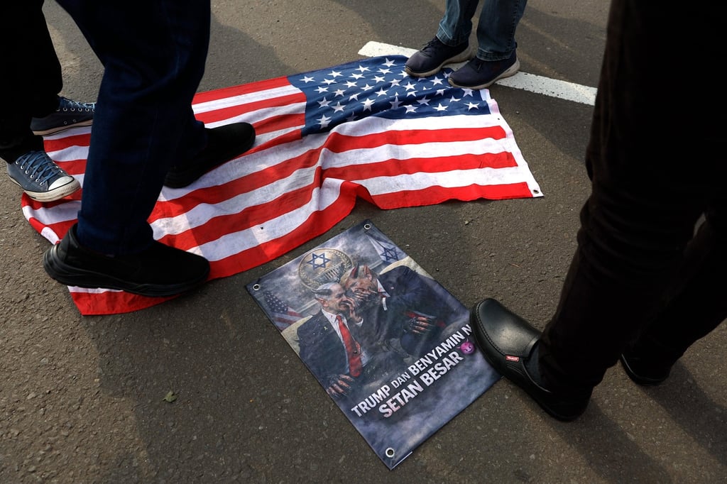 Indonesian protesters step on a US flag during a rally outside the US embassy in Jakarta on March 13. Photo: EPA Indonesian protesters step on a US flag during a rally outside the US embassy in Jakarta on March 13. Photo: EPA