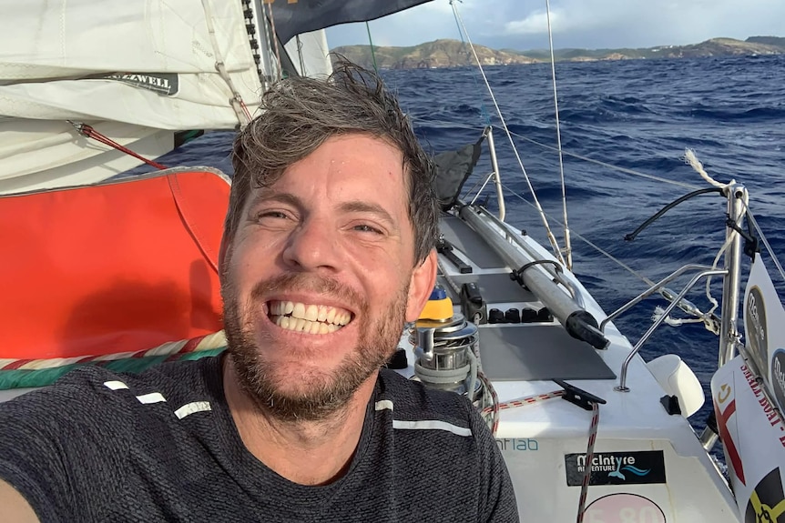 A selfie of a man smiling while on a yacht at sea.