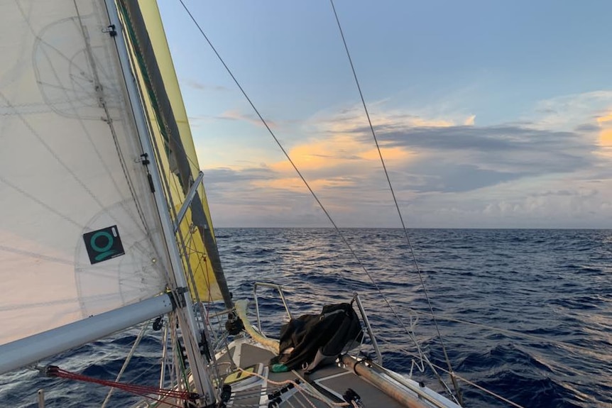 A boat sails on open ocean.