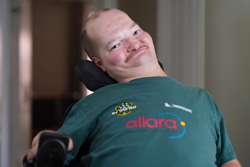 Kieran Watts in a powerchair and green top