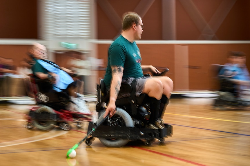 Radial blur photo of player in powerchair in action holding stick