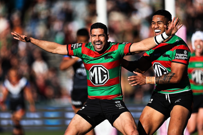 A man celebrates a try in an NRL game 