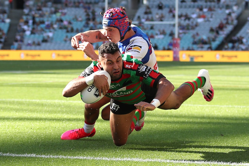 Alex Johnston dives over in the corner to score a try for South Sydney 