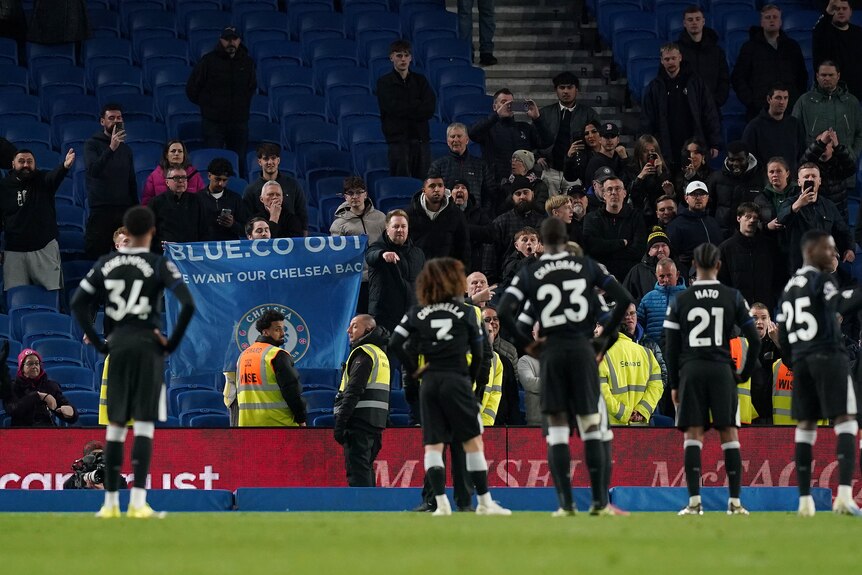 Chelsea players stand in front of their fans