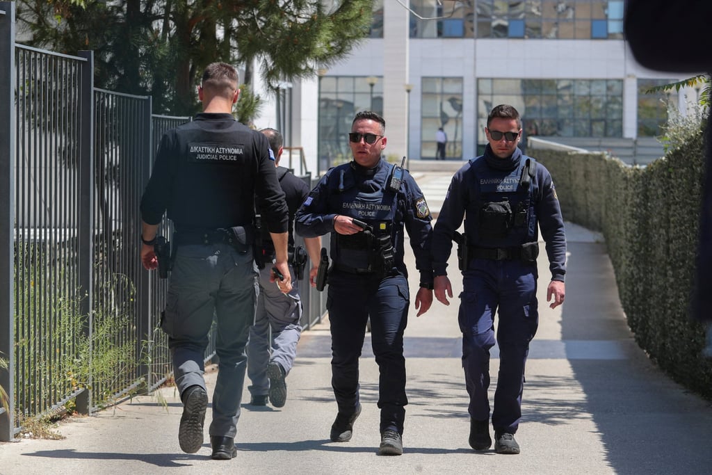 Police officers outside the Athens Court of Appeal following a shooting that left several people wounded. Photo: Sotiris Dimitropoulos/Eurokinissi via Reuters