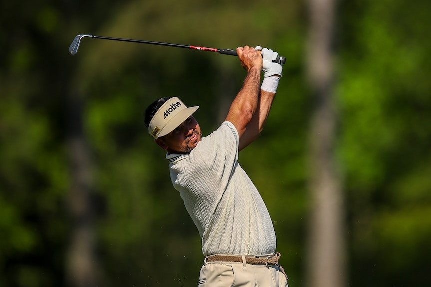 Jason Day hits a shot on the 12th hole at the Masters third round.