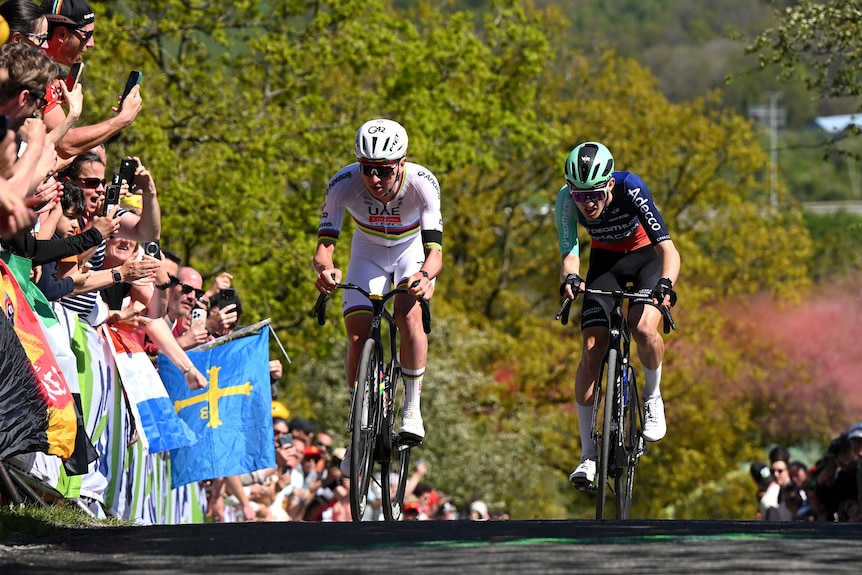 Tadej Pogacar races next to Paul Seixas