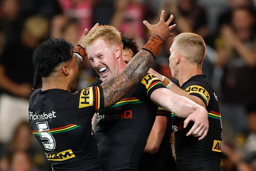 Tom Jenkins celebrates a try in a rugby league match 