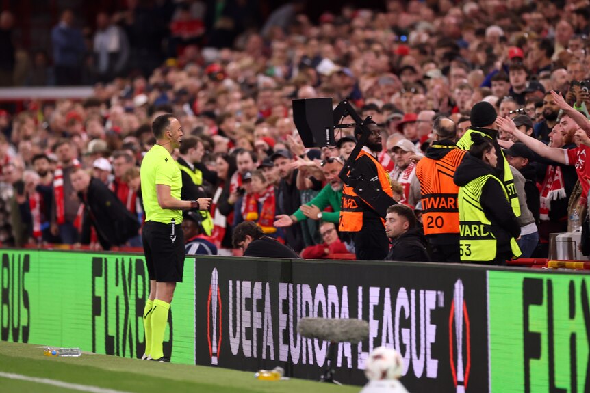 A referee checks a VAR screen