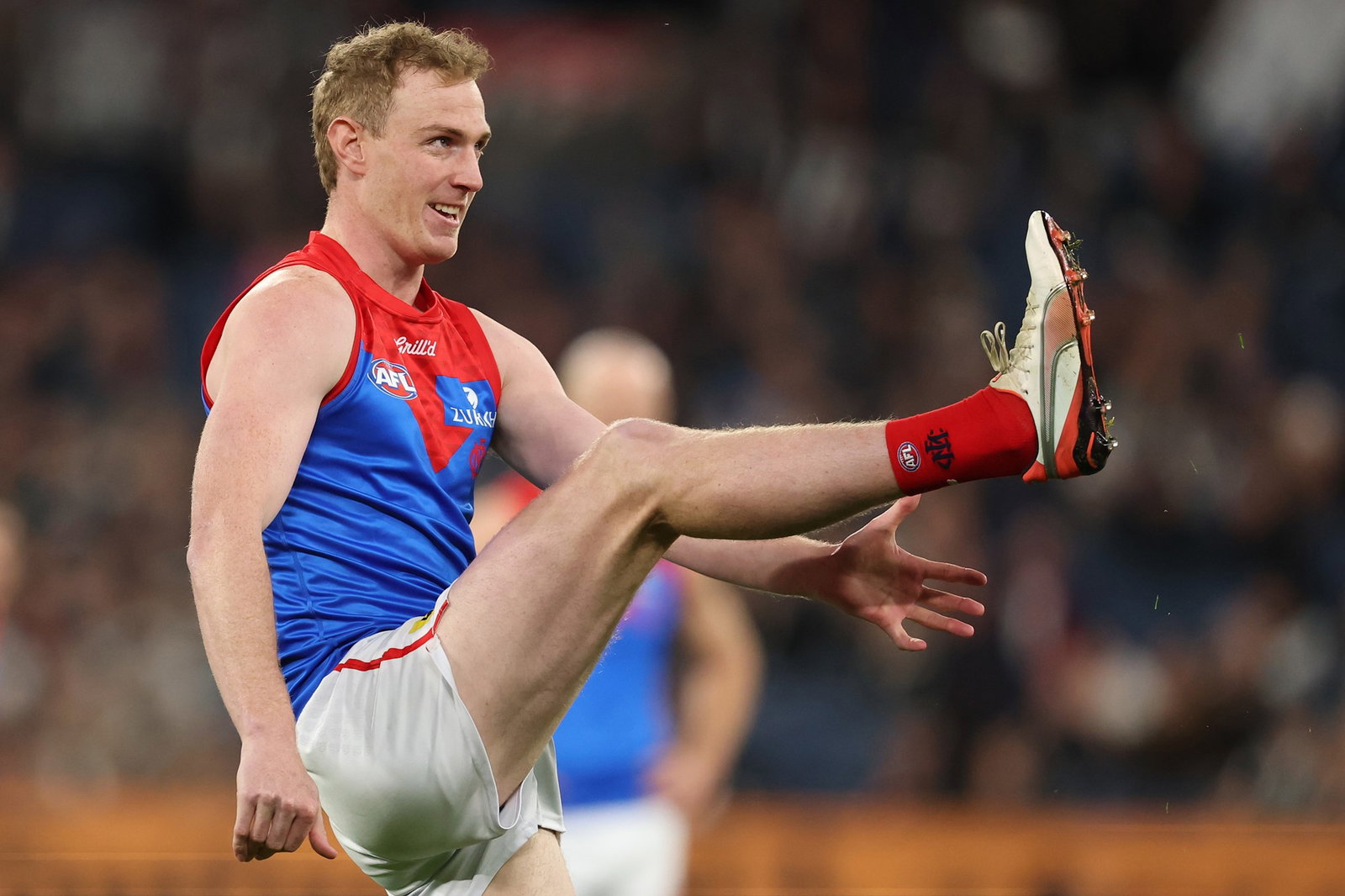 Harrison Petty kicks the ball for the Demons.