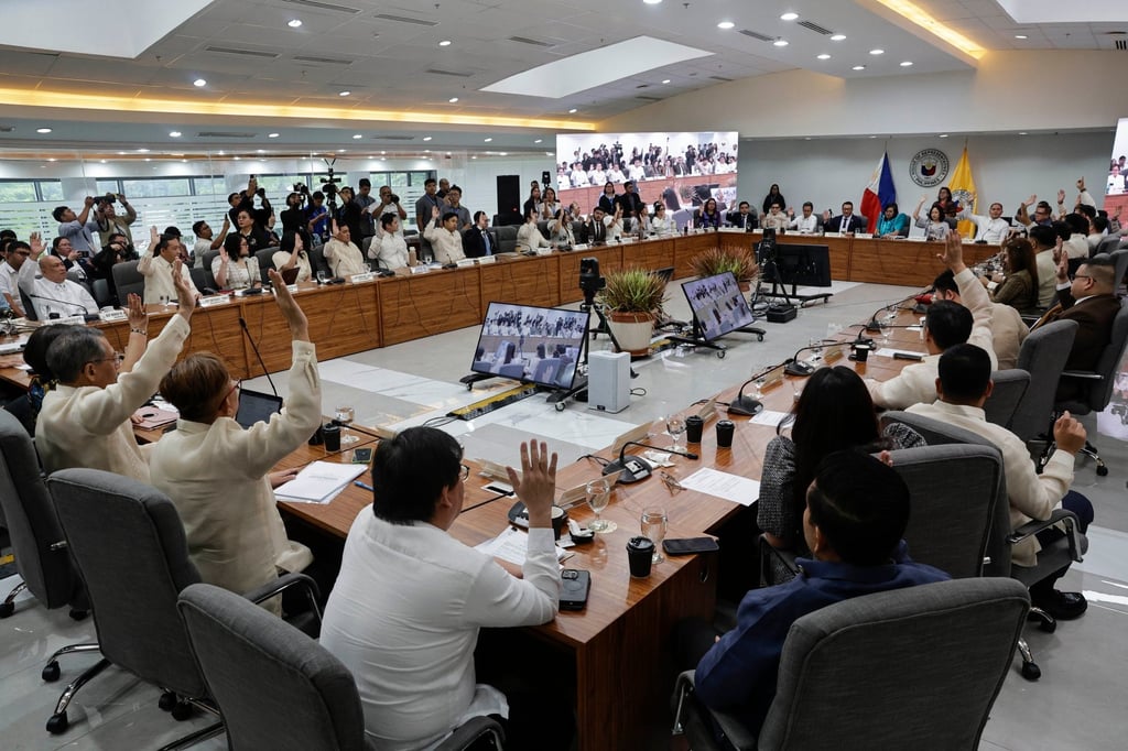 Members of the House of Representatives Justice Committee raise their hands to vote during a committee hearing in Quezon City, the Philippines, on Monday. Photo: EPA Members of the House of Representatives Justice Committee raise their hands to vote during a committee hearing in Quezon City, the Philippines, on Monday. Photo: EPA