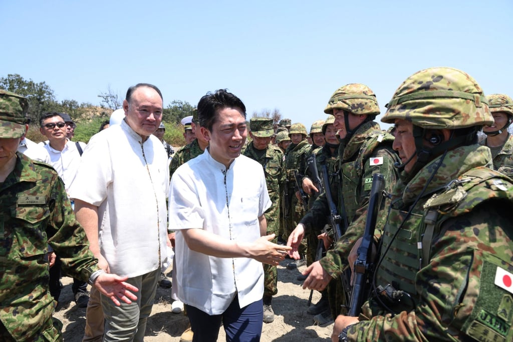 Japanese Defence Minister Shinjiro Koizumi (centre) greets troopers beside his Philippine counterpart Gilberto Teodoro Jnr during the Balikatan drills in Paoay on Wednesday. Photo: Philippine Department of National Defence via AP Japanese Defence Minister Shinjiro Koizumi (centre) greets troopers beside his Philippine counterpart Gilberto Teodoro Jnr during the Balikatan drills in Paoay on Wednesday. Photo: Philippine Department of National Defence via AP