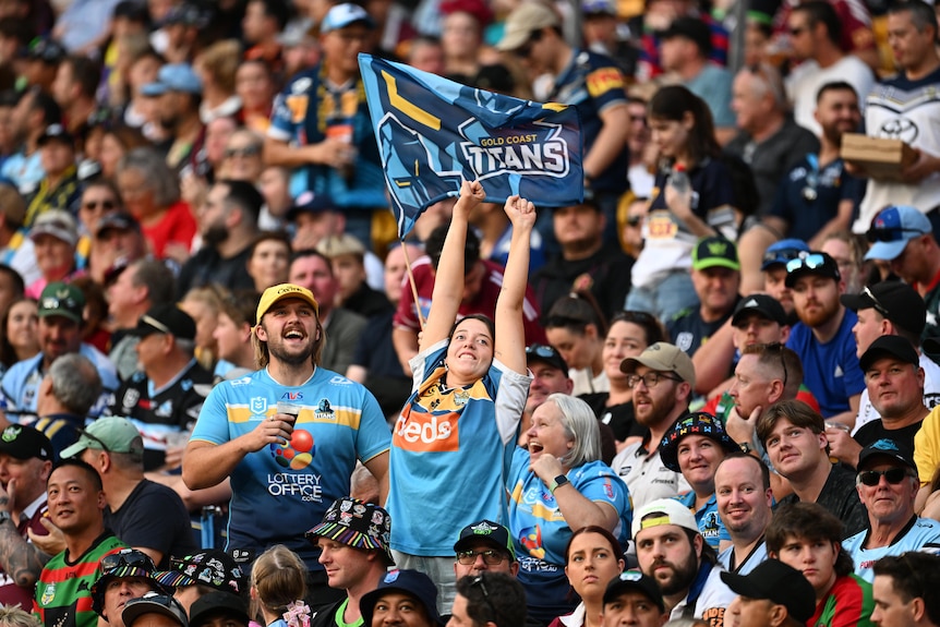 Two fans cheer during the NRL's Magic Round