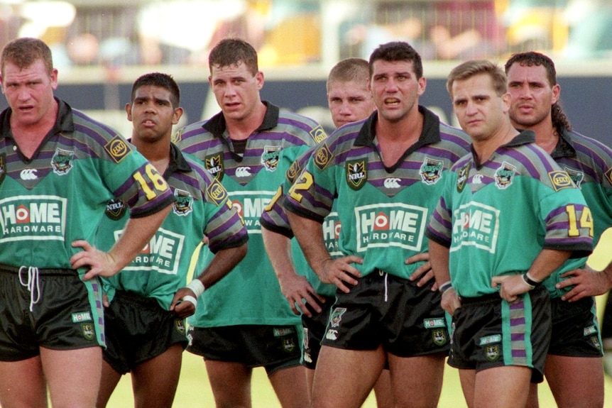 A group of rugby league players look despondent after conceding a try