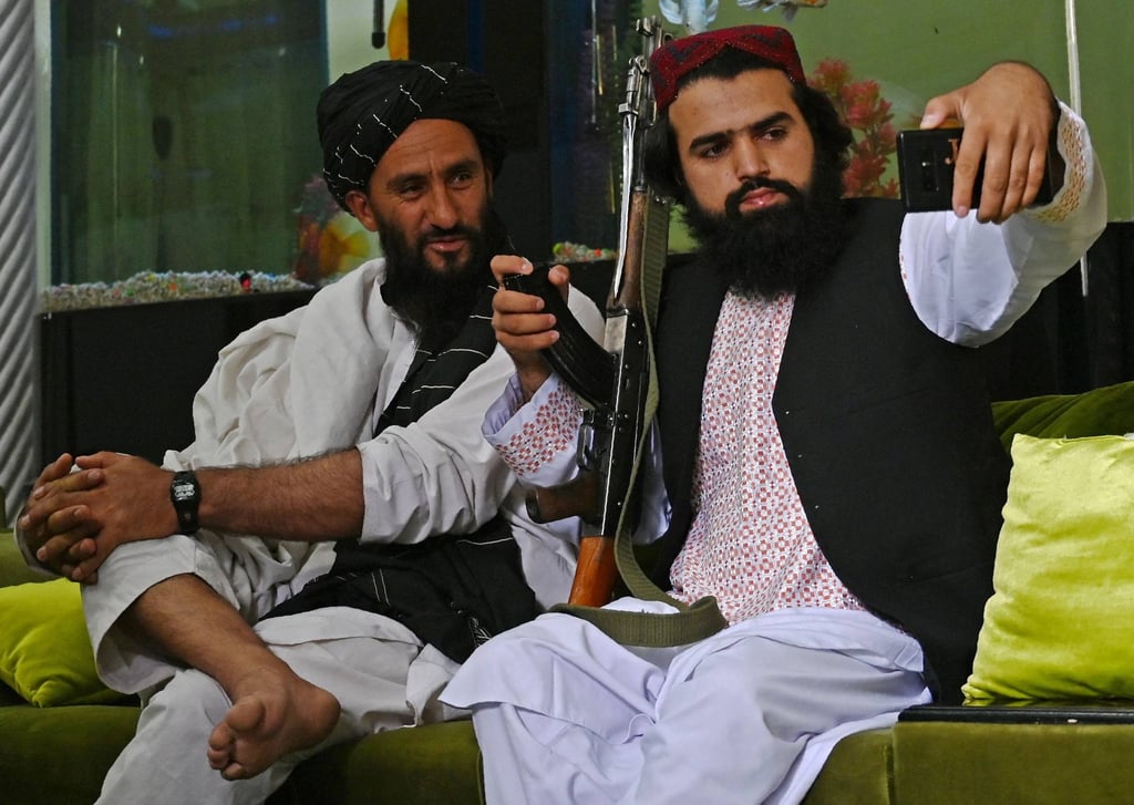 Taliban fighters pose for a selfie after taking over the home of Afghan warlord Abdul Rashid Dostum in Kabul on September 11, 2021. Photo: AFP