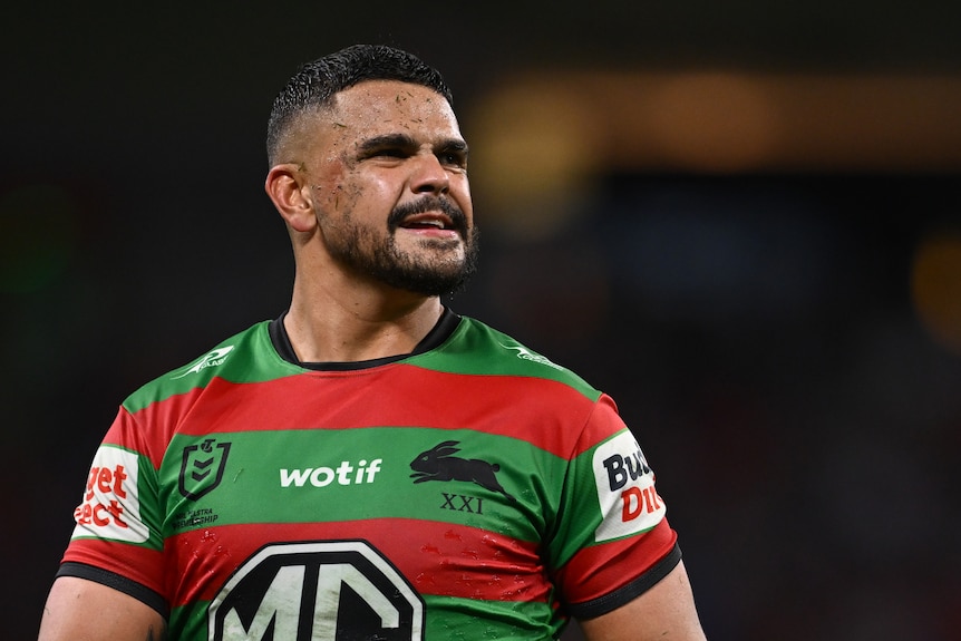 NRL player Latrell Mitchell tired, looking in the distance, on the field