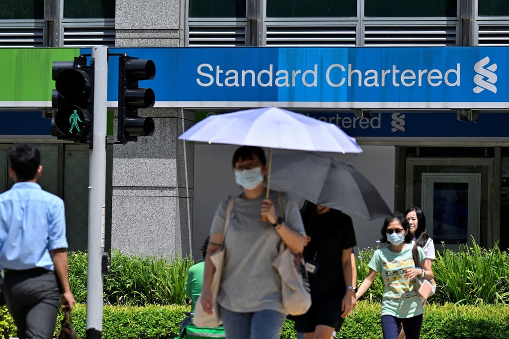 A Standard Chartered bank in Singapore. The lender has said it will cut more than 15 per cent of its corporate function roles by 2030 due to its increasing use of AI. Photo: Reuters