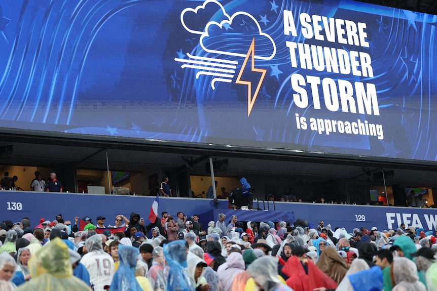 A sign warning fans a "severe thunderstorm is approaching" at the World Cup.
