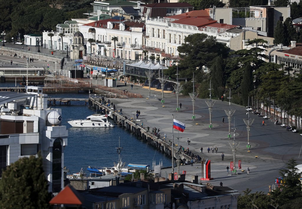 The Russian flag flies on an embankment in Yalta, a holiday resort in Crimea, in 2025. Photo: Reuters