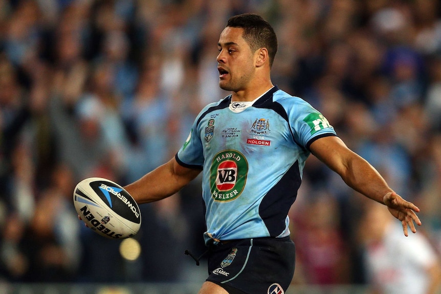Hayne in blue runs the ball over the dead ball line.