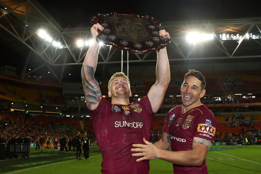 Two men celebrate winning the State of Origin series for Queensland