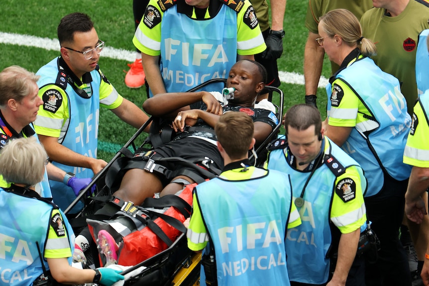 Ismael Kone is stretchered off by FIFA medical staff after suffering an injury