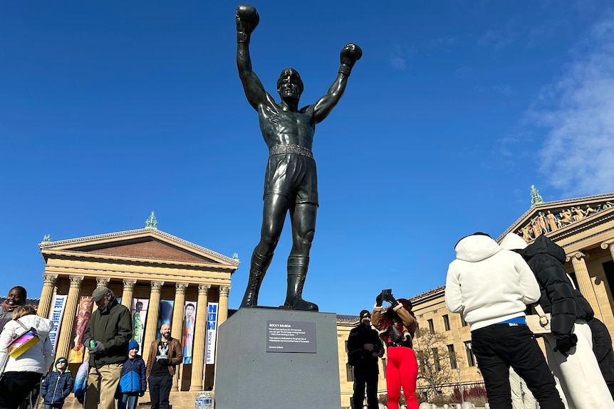 Tourists gather around the Rocky statue in Philadelphia