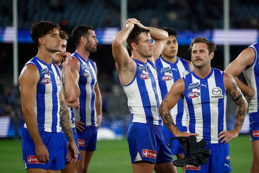 Kangaroos players standing looking disappointed