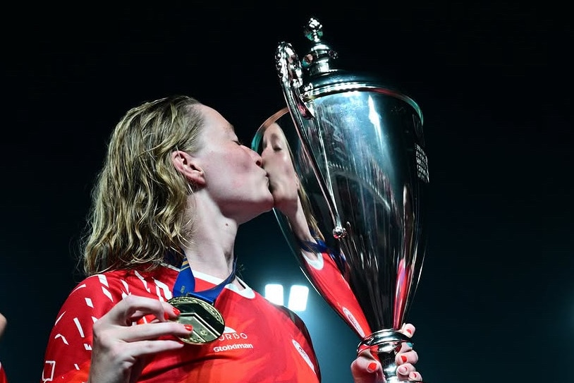 Abby Andrews kisses the champions league trophy