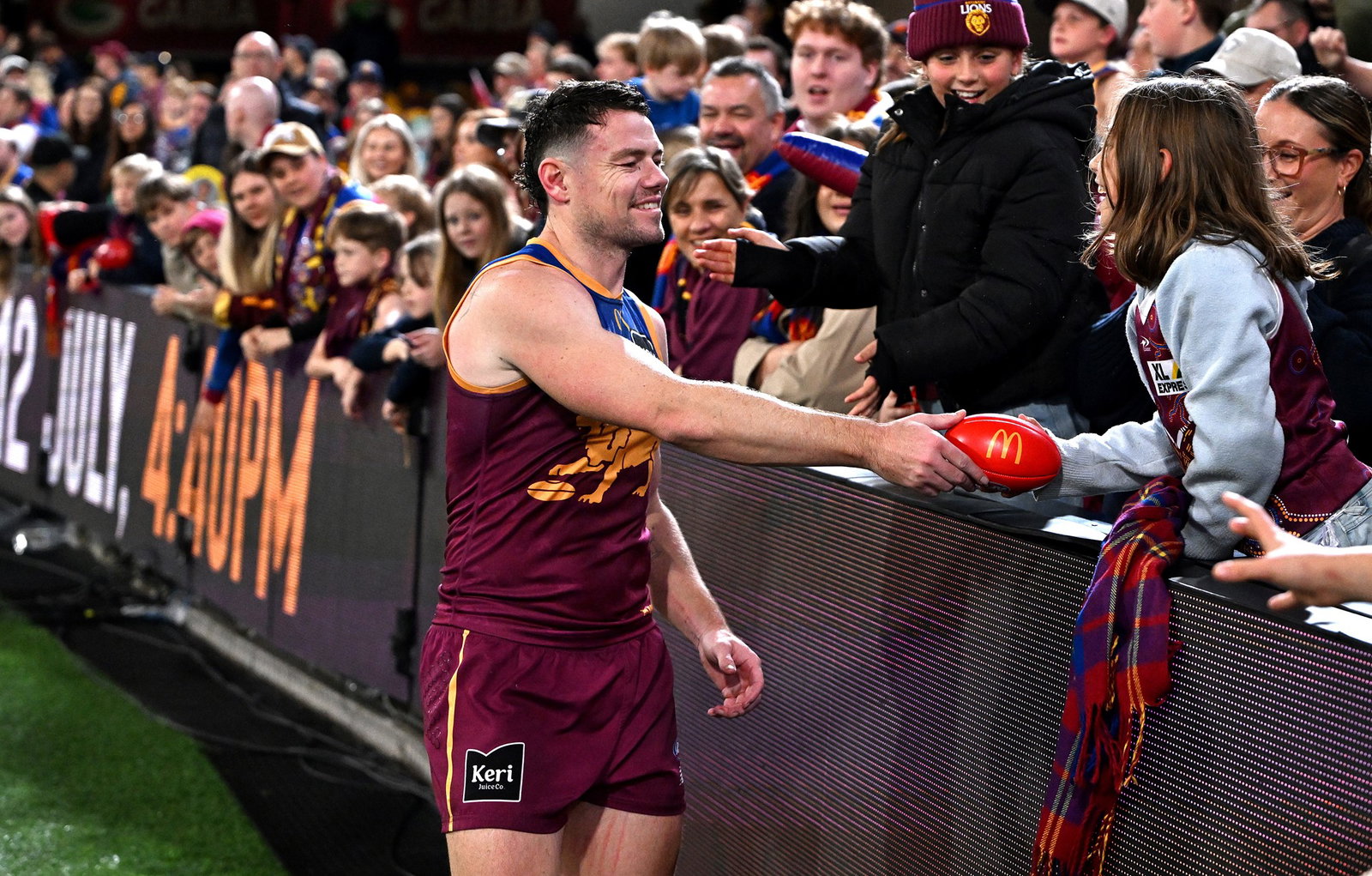 Lachie Neale of the Lions engages with a young fan after the round 16 AFL match between Brisbane Lions and Sydney Swans at The Gabba, on June 25, 2026, in Brisbane, Australia.