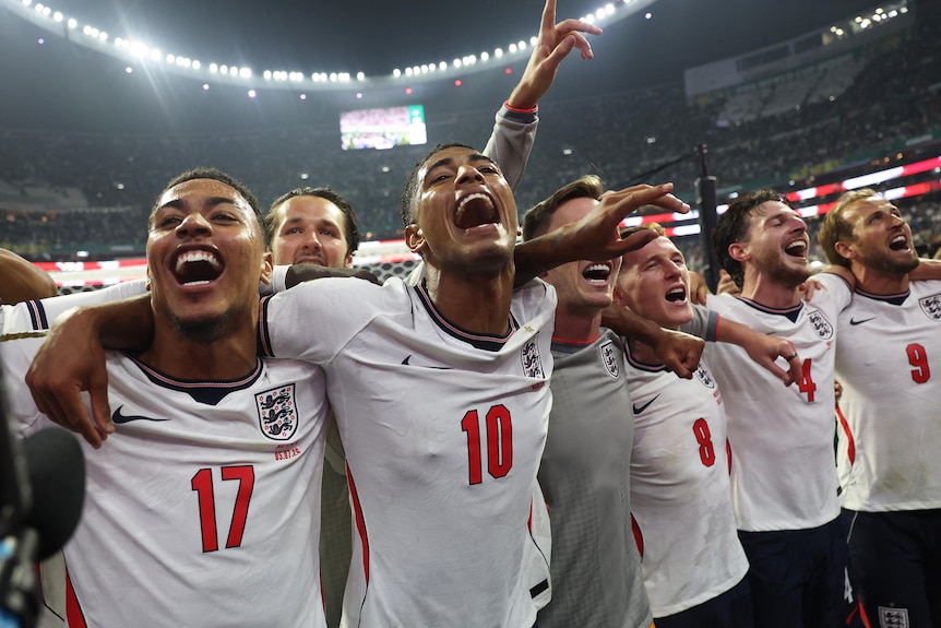 England players celebrate together, arm in arm