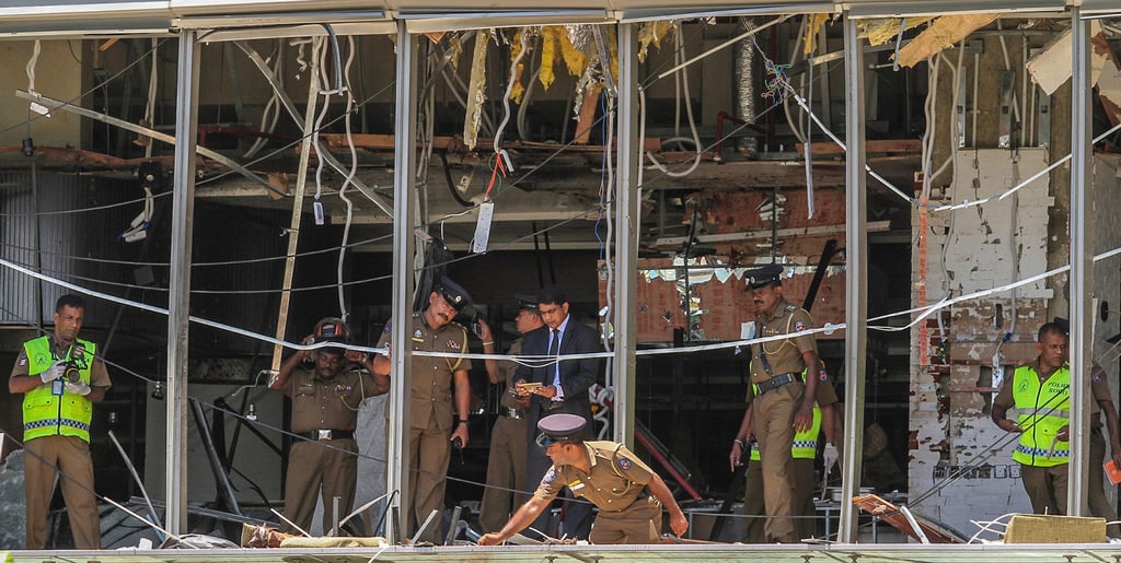 Sri Lankan police officers inspect the site of a fatal bombing at a hotel in Colombo in 2019. Photo: AP Sri Lankan police officers inspect the site of a fatal bombing at a hotel in Colombo in 2019. Photo: AP