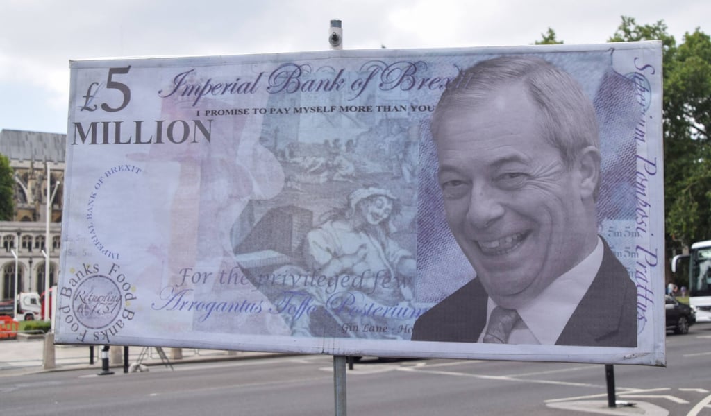 A mock £5 million note with a portrait of Nigel Farage is displayed during the weekly anti-Brexit protest in Parliament Square on Wednesday. Photo: dpa A mock £5 million note with a portrait of Nigel Farage is displayed during the weekly anti-Brexit protest in Parliament Square on Wednesday. Photo: dpa